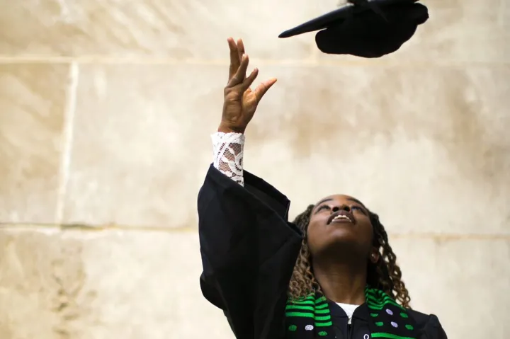 2021 graduate Nina Uzoigwe throws her cap.