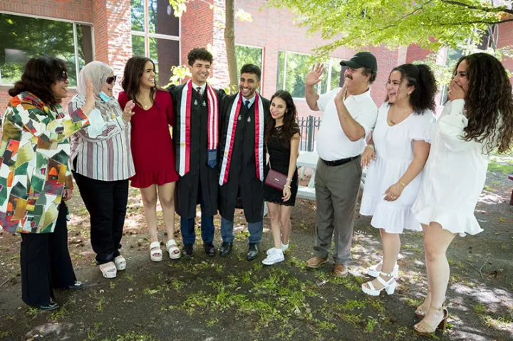 The families of Harvard friends Abdelaziz “Zizo” Nasr Bahnasy ’21 (center, left) of Currier House and Hassam Nasr Mabed ’21 (center, right) of Winthrop House meet on campus.