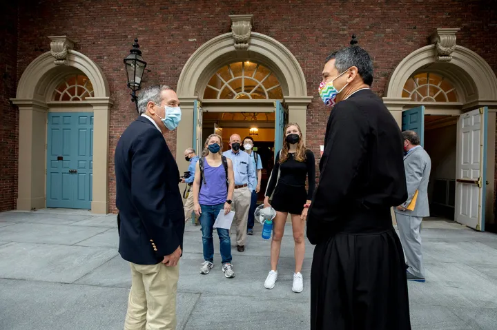 Harvard President Larry Bacow (left) and the Rev. Matthew Ichihashi Potts spoke following Morning Prayers at the Memorial Church.