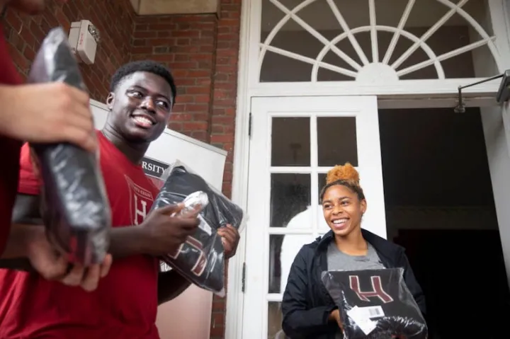 Football player Kwaku Adubofour ’24 and DaLoria Boone ’22 of women's track and field receive their "Major H" varsity letter sweaters at the first distribution day since 2019.