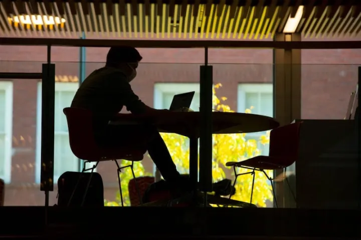 The Harvard community will continue to wear masks and distance while indoors.