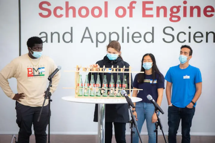 From left, Kwaku Adubofour (‘24), Victoria Levy (‘25), Sophia Liang (‘23) and Christian Rodriguez (‘23) present their instrument at the end-of-semester Symphosium concert on Dec. 6 in the Science and Engineering Complex Atrium in Allston.