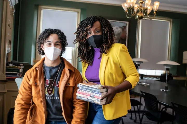 DeAnza Cook (right) with student member Luke Walker at Cabot House Library, where the Cabot Prison Abolition Book Club meets.
