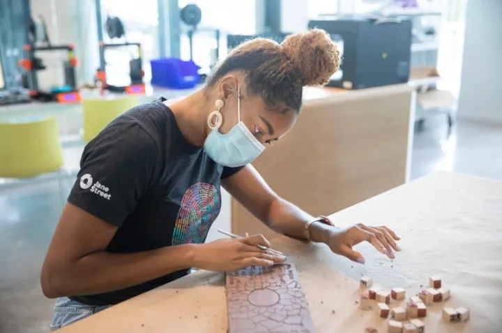 Senior DaLoria Boone personalizes a brick for the "Inclusions" art installation on display in Harvard Yard through May 2.