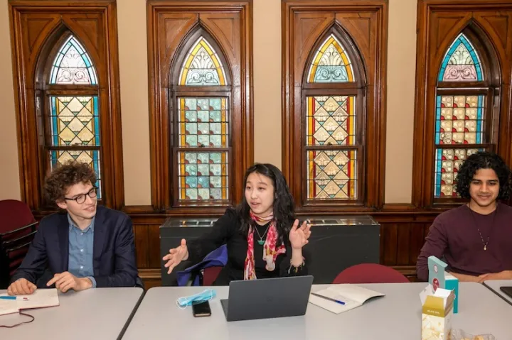 “The goal of the salon is to kind of examine what that might look like. Are there fundamental differences between two fields that prevent them from working together?” asked Julie Heng (center). The salon was founded by Heng, Henry Haimo (left), and Chinmay Deshpande (right).