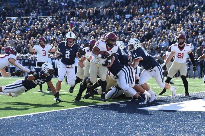 Football players at end zone of Harvard Yale