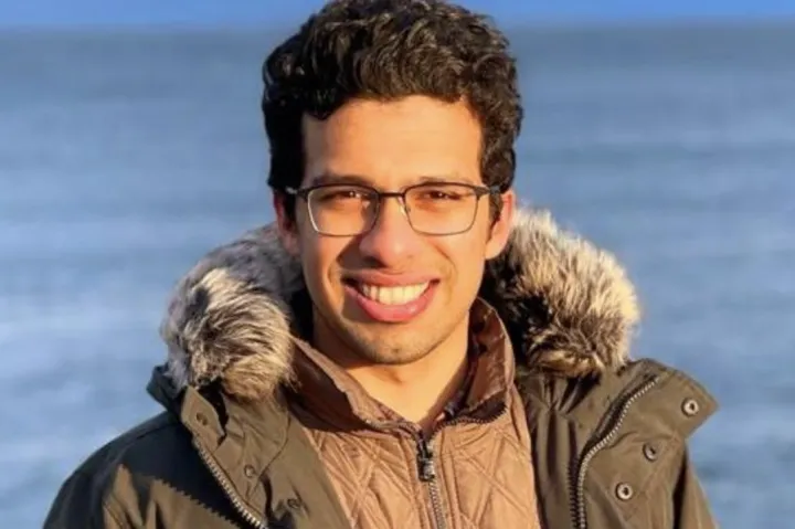 Computer science student, Mate, smiling. 