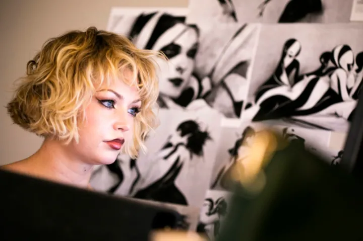 Animator Dasha Bough ’23 staring off screen with a pointed look in front of a black and white background. 