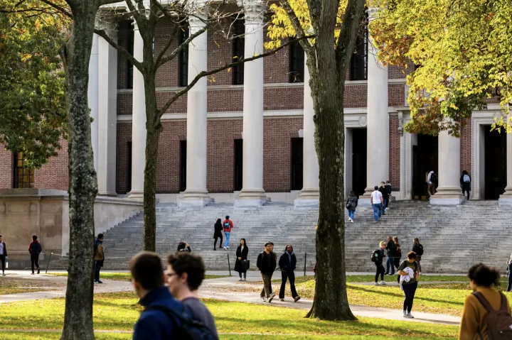 Students walking through Harvard Yard in front of Widener Library. 