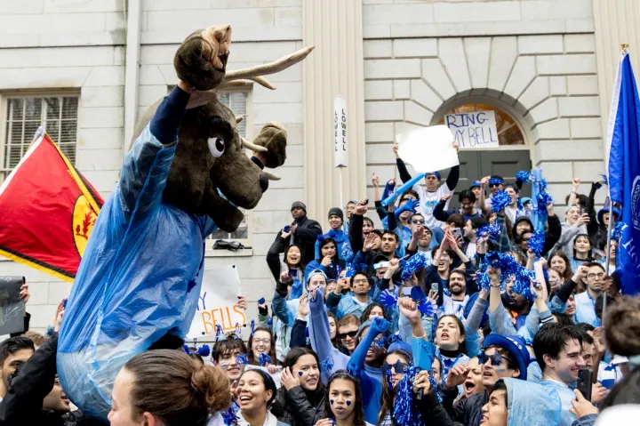 Lowell House students cheer for their House on the steps of University Hall in Harvard Yard on Housing Day.