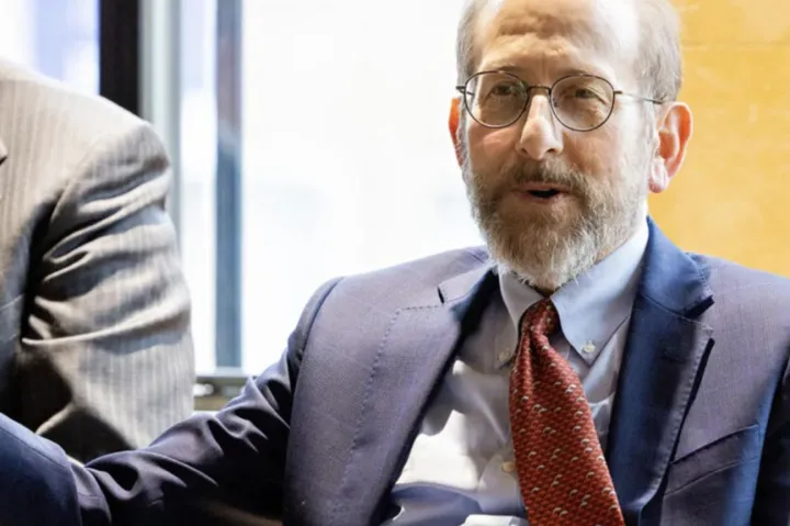 During his trip to the U.K., Interim President Alan Garber spoke with the Herchel Smith Scholars at Emmanuel College, Cambridge. Eric Miska (left), Herchel Smith Professor of Molecular Genetics, moderated the symposium