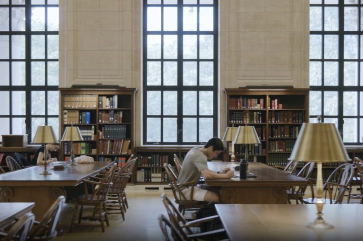 Interior shot of tables in Widener Library with students at desks