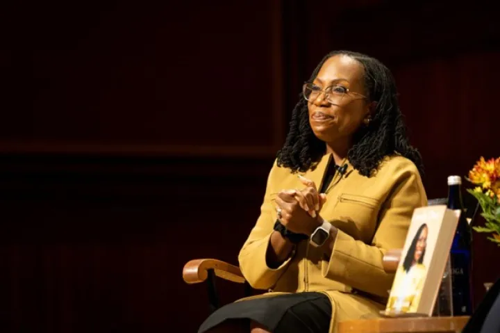 Women sitting in chair clasping hands