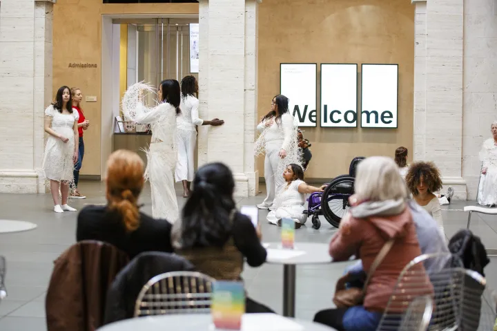 Audience members watch performance inside Harvard Art Museum