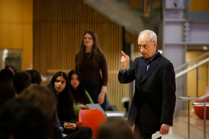 Speaker engaging with audience in a lecture hall
