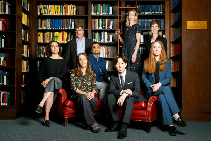 Dean Sean Kelly (second from left) pictured here with professors who will be teaching introductory arts and humanities courses in the fall and spring. They include Lauren Kaminsky (from left), Raquel Vega-Durán, Neel Mukherjee, Spencer Lee-Lenfield, Laura van den Berg, Karen Thornber, and Moira Weigel.