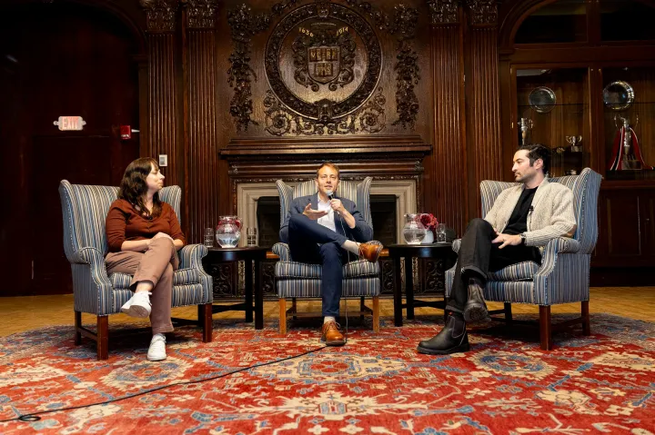Harvard canine researcher Erin Hecht (left) and photographer Elias Weiss Friedman (right) of “The Dogist” Instagram account join Faculty Dean David Deming for a talk at Kirkland House.