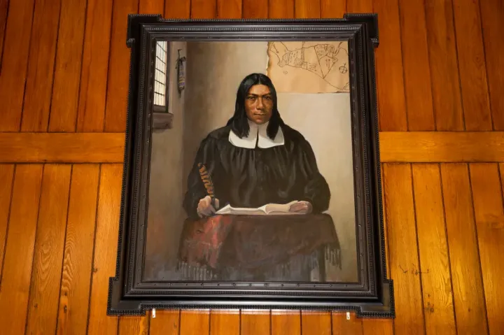 A portrait of Caleb Cheeshahteaumuck, the first Native American to graduate from Harvard College, hangs in Annenberg Hall.