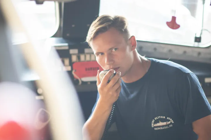 Dmitry holds a radio to prepare for boat mission readiness. 