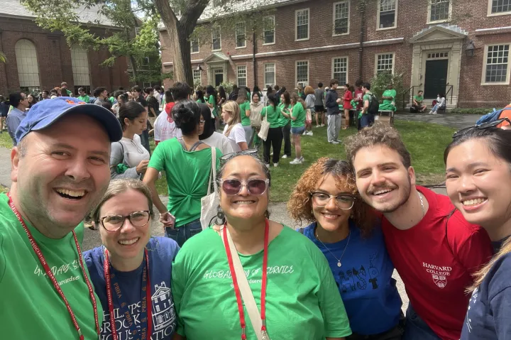 A group of staff and students taking a selfie before the day of service begins.