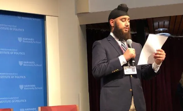 a student on stage at Harvard's JFK Jr. Forum