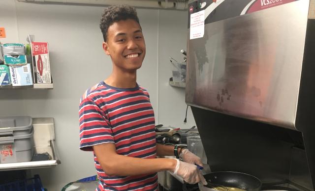 Student cooking in kitchen