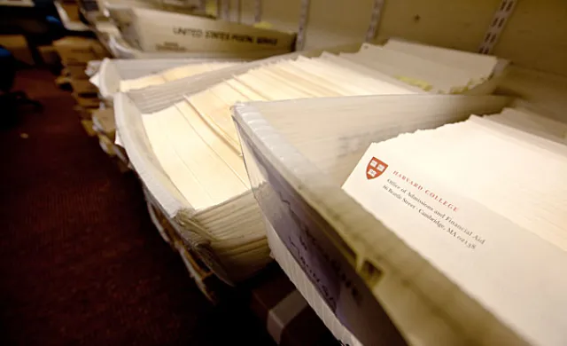 Dozens of admissions packets in mailing bins