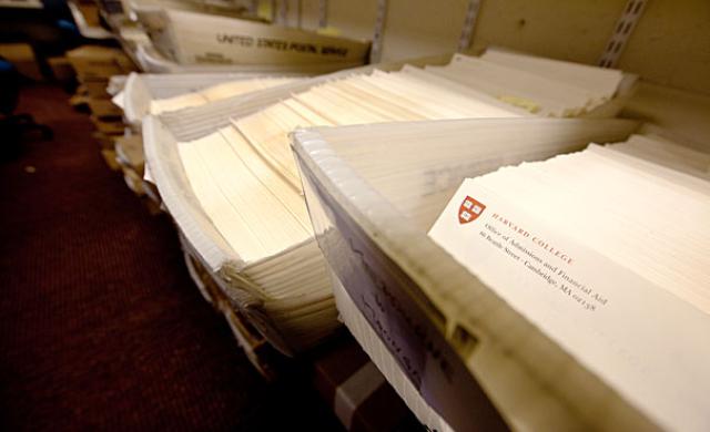 Dozens of admissions packets in mailing bins
