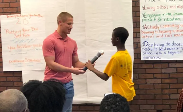 Two Students holding a microphone