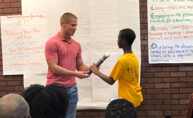 Two Students holding a microphone
