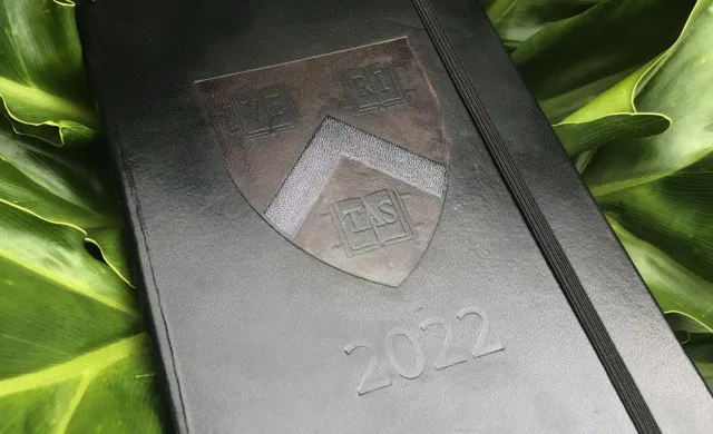 Black journal with Harvard logo and 2022 imprinted on the front