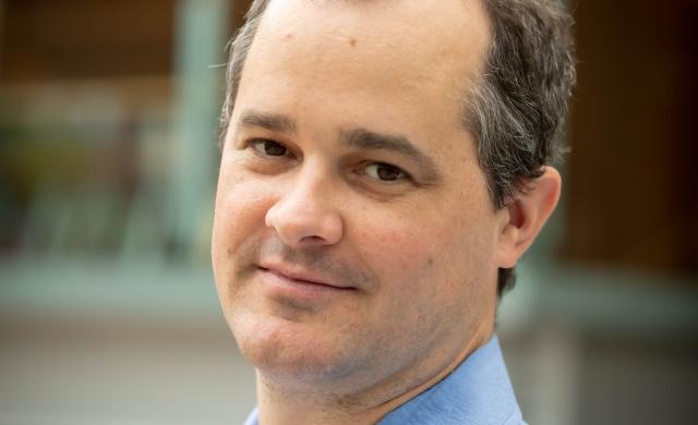 A portrait of professor Dustin Tingley.
