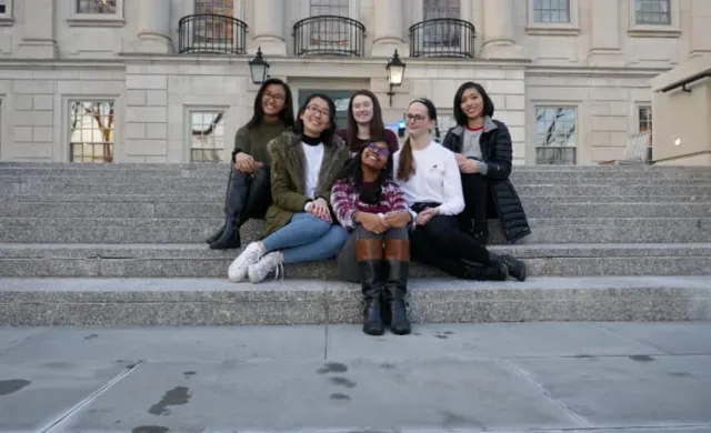 6 ladies sitting on the steps outside of Winthrop House