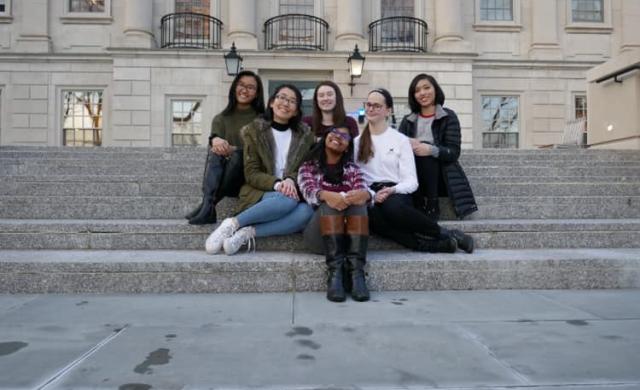 6 ladies sitting on the steps outside of Winthrop House