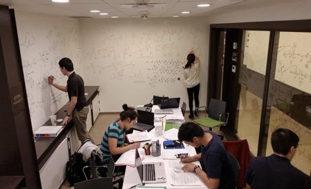 5 students studying in the basement of dorm.