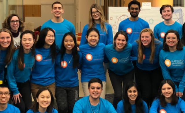 Group of smiling students in blue shirts