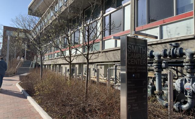 Mt. Auburn Street Side of Harvard University Health Services showing the sidewalk, building and the entrance sign