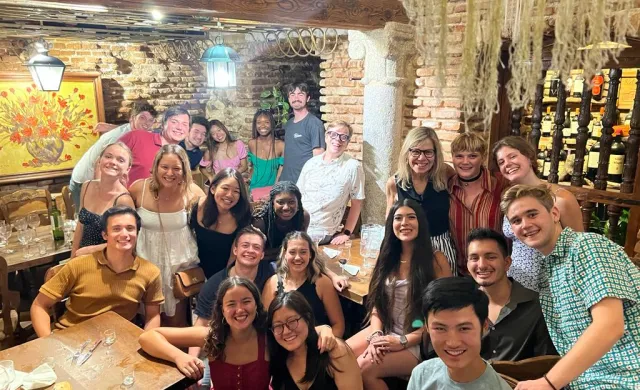 Group picture of students and professors at final dinner celebration 