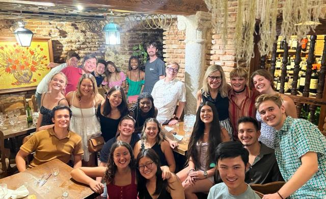 Group picture of students and professors at final dinner celebration 