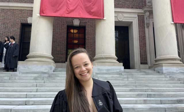 Harvard graduate Perrin Price standing on Widener Library steps.