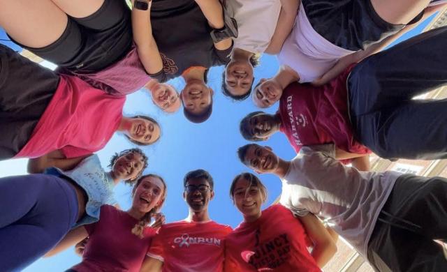 A group of runners looking down at a camera.