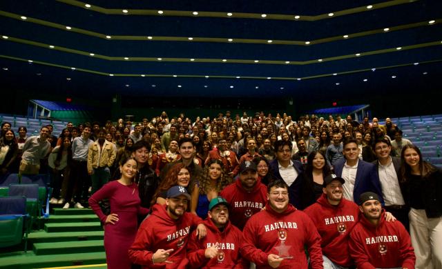 Grupo Frontera band members with the event's guests. People are smiling and happily posing for the picture.  