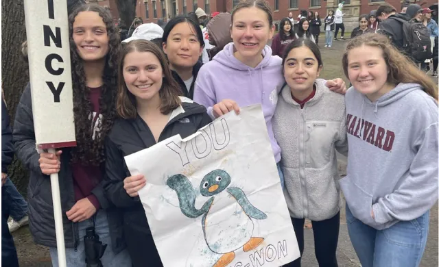 Blocking group posed with Quincy signs 