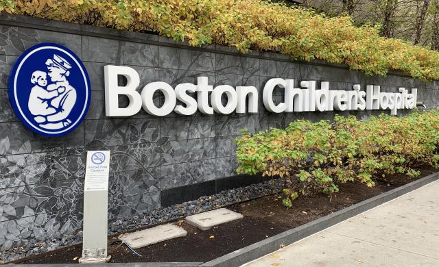 Picture of a Boston Children's Hospital sign placed across a stone wall.
