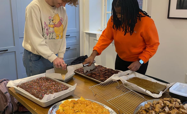 My coworker and I cutting treats to be served at Lowell Tea.