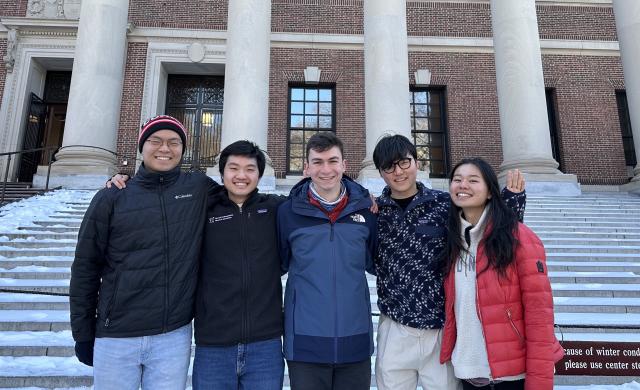 Picture of Raymond and his blocking mates standing in front of the steps of Widener Gate.