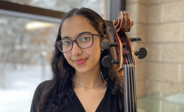 The author with her cello standing.