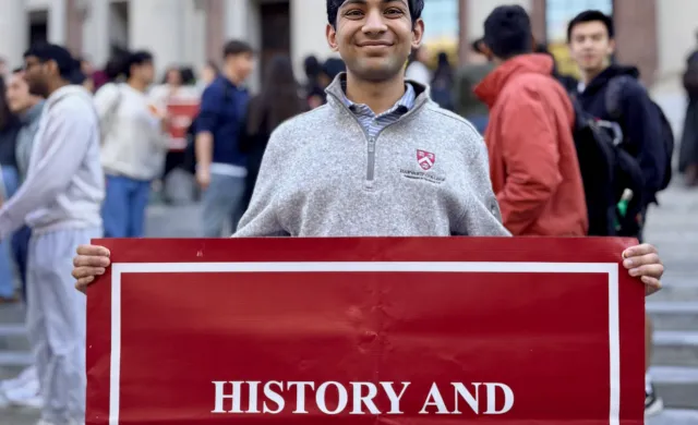 I pose with the sign for History and Science in front of Widener Library