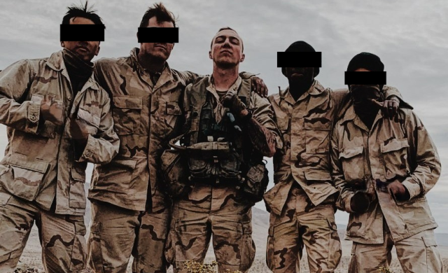 A group of soldiers pose for a picture during a training exercise