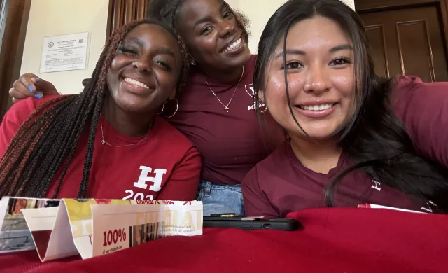 Three students smiling for a picture.